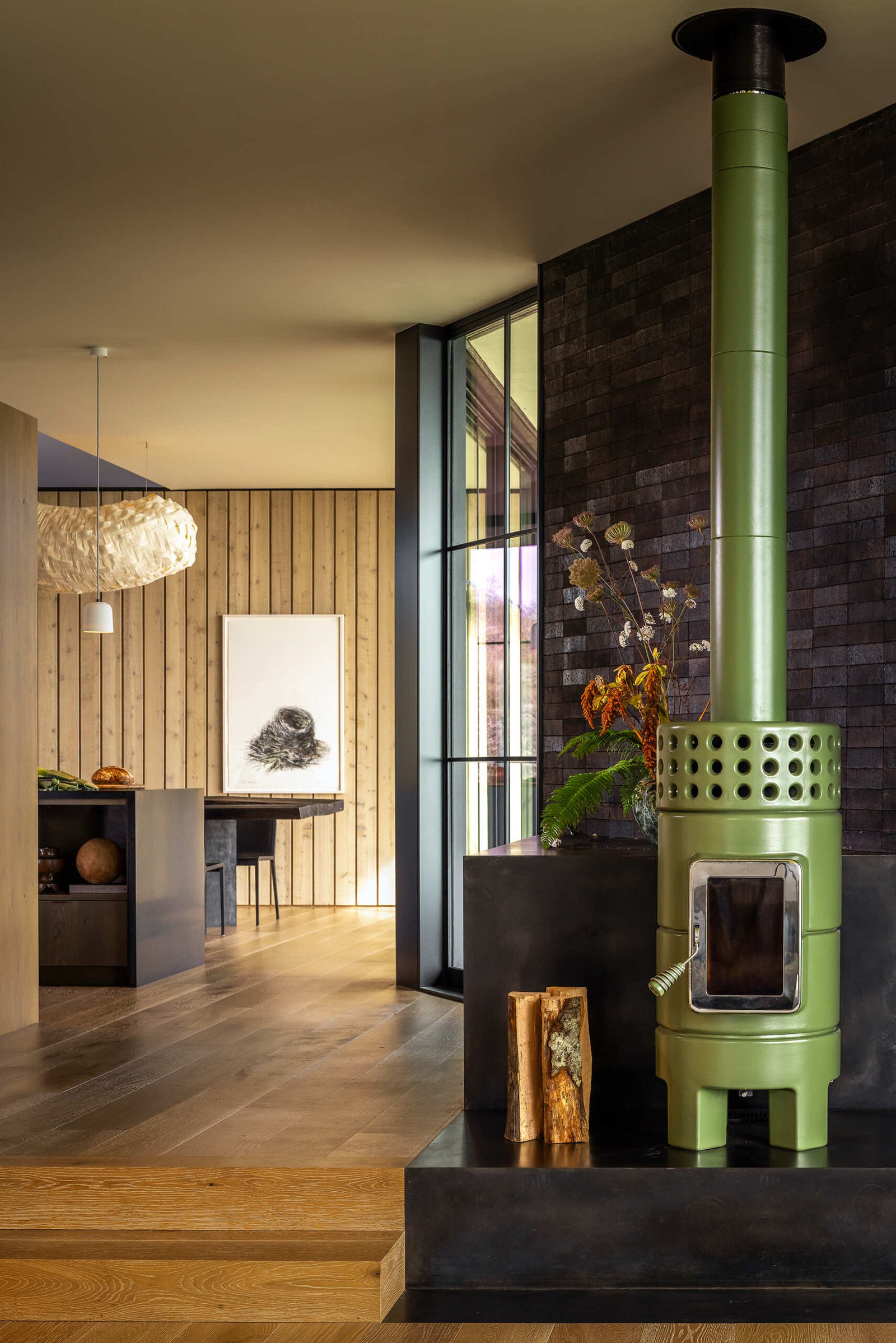 Neutral interiors and large glass doors frame uninterrupted views of water and rock.