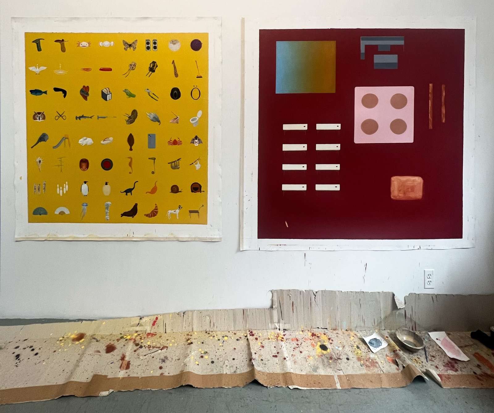 Two red-hued canvases leaning on top of each other containing diagrammatic zones