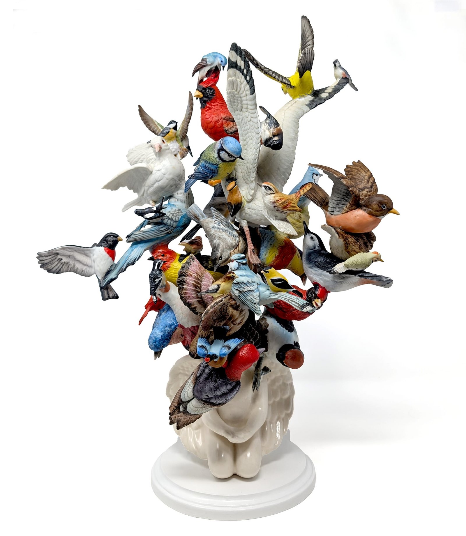 a ceramic sculpture made using numerous found ceramic bird figurines, assembled together in a jumbled composition