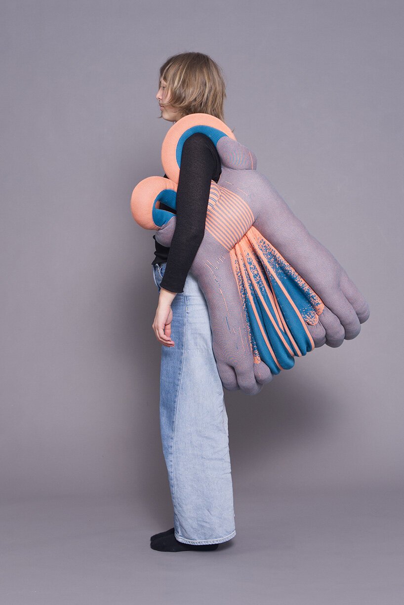 A person wearing a large-scale structural knit piece