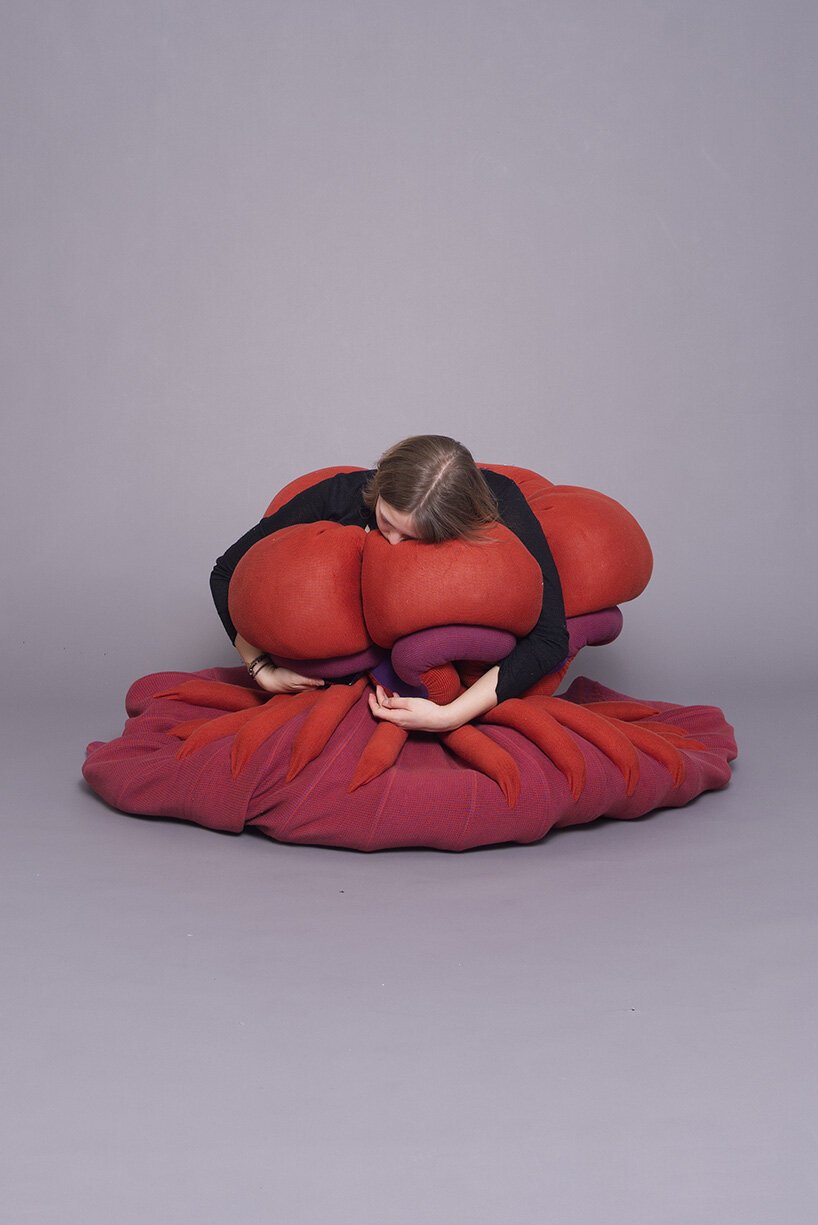 Soft enclosure created by a heavy-knit textile wrapping around a person