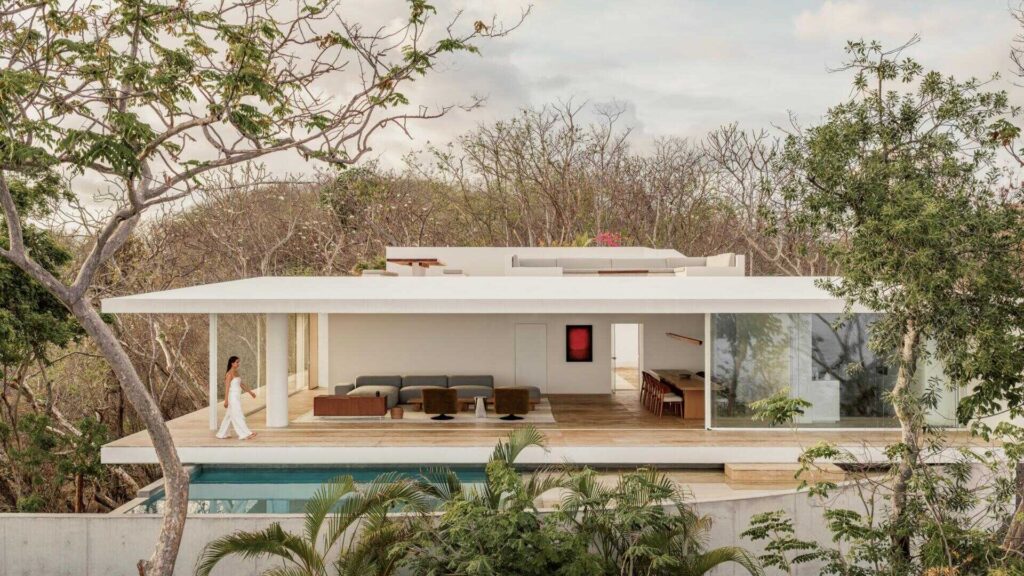 Casa Malonic in Zihuatanejo, Mexico, designed by HW Studio, uses white walls, sandy floors, shade and simple architectural forms to create a home shaped by the surrounding sea and jungle.