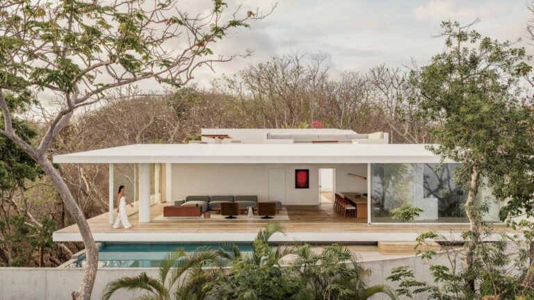 Casa Malonic in Zihuatanejo, Mexico, designed by HW Studio, uses white walls, sandy floors, shade and simple architectural forms to create a home shaped by the surrounding sea and jungle.